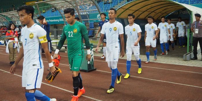 Para pemain timnas U-23 Malaysia saat bertanding melawan timnas U-23 Jepang  dalam babak 16 besar Ai