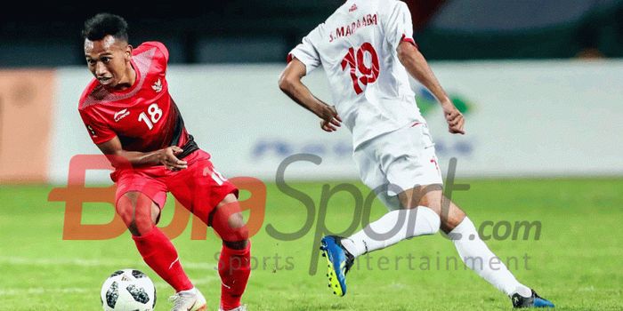 Pemain Timnas U-23 Indonesia, Irfan Jaya, mengecoh pemain Palestina pada pertandingan Grup A Asian Games 2018.