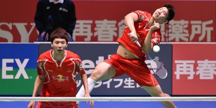  Pasangan ganda putra China, Li Junhui (kiri)/Liu Yuchen, mengembalikan kok dari pasangan Korea Sela