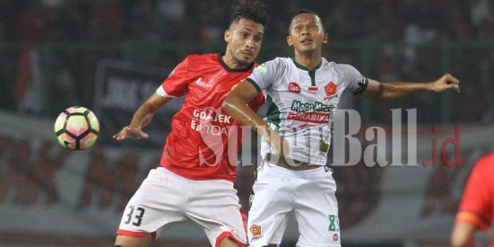 Penyerang PS TNI, Sansan Fauzi (kanan) duel di udara dengan bek Persija asal Brasil, Willian Pacheco