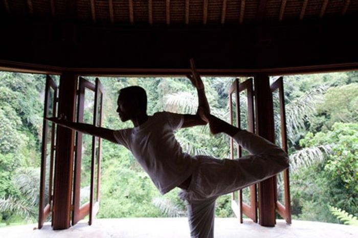 Wayan, seorang yogi, sedang melakukan yoga di salah satu paviliun di Bali.