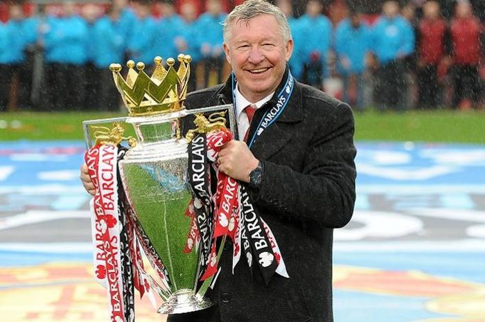 Manchester United manager Sir Alex Ferguson celebrates with the Barclays Premier League trophy, afte