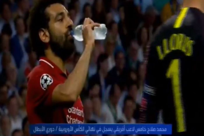 Penyerang Liverpool, Mohamed Salah, meminum air di sela-sela laga babak pertama final Liga Champions kontra Tottenham, Minggu (2/6/2019), dini hari WIB.