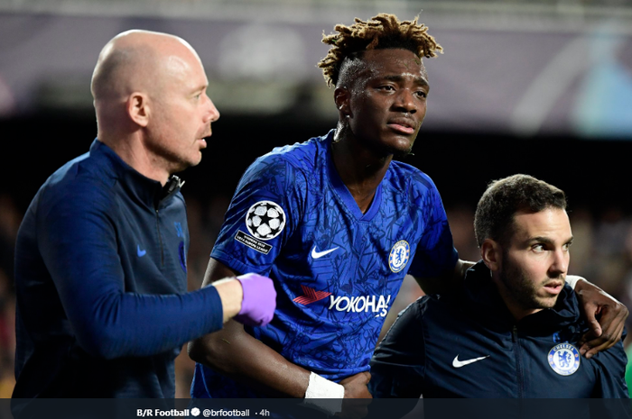 Striker Chelsea, Tammy Abraham (Tengah) sedang dipandu setelah mengalami cedera diu bagian pinggulnya kala timnya bersua Valencia di ajang Liga Champions, Kamis (28/11/2019)