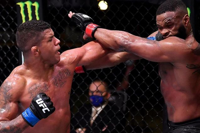 Gilbert Burns (kiri) memukul Tyron Woodley (kanan) pada seri UFC bulan Mei lalu.