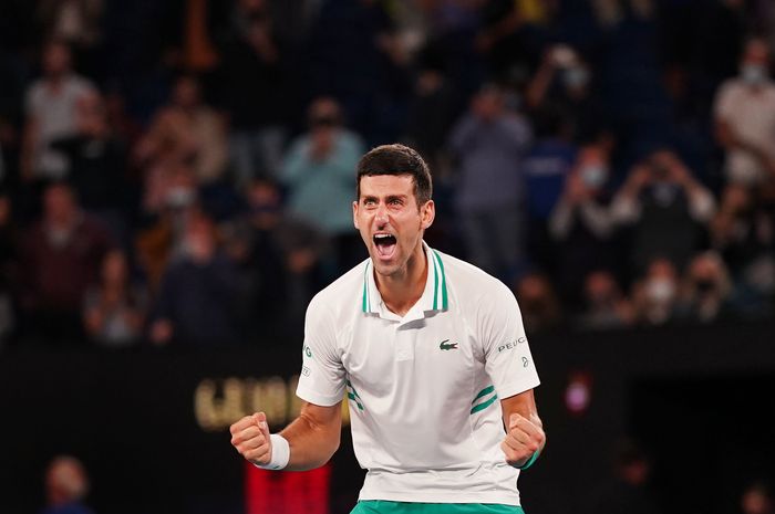 Petenis putra Serbia, Novak Djokovic, bereaksi setelah memastikan diri sebagai juara Australian Open 2021, Minggu (21/2/2021).