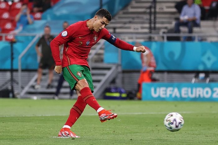 Megabintang Portugal, Cristiano Ronaldo, mengeksekusi penalti ke gawang Prancis pada fase grup EURO 2020.