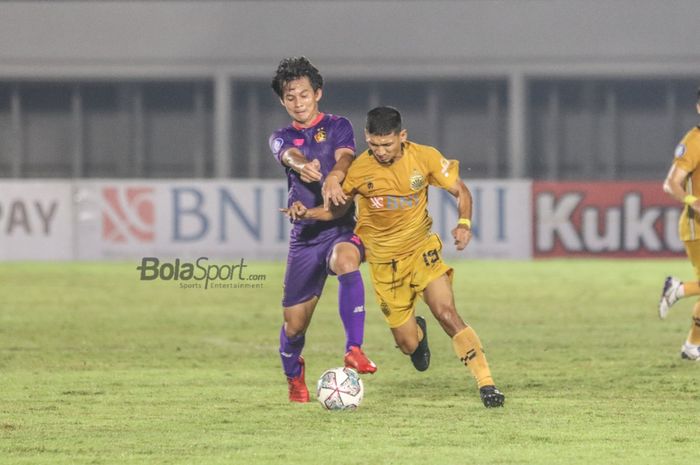 Pemain Bhayangkara FC, Teuku Muhammad Ichsan alias TM Ichsan (kanan), sedang berebut bola dengan pilar Persik Kediri, Risna Prahalabenta (kiri), dalam laga pekan kelima Liga 1 2021 di Stadion Madya, Senayan, Jakarta, 29 September 2021.