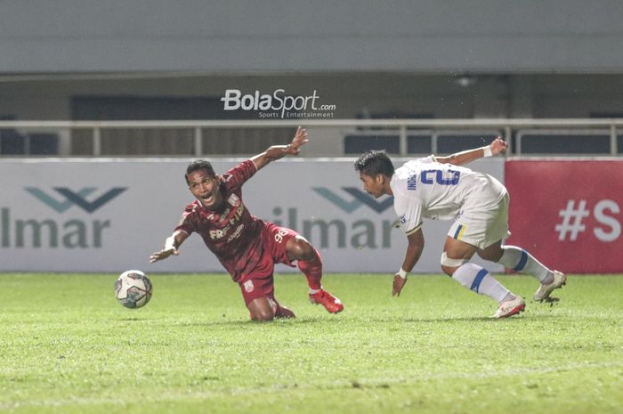 Bek sayap kiri Persis Solo, Abduh Lestaluhu (kiri), sedang berusaha menggapai bola dalam laga pekan ketiga babak delapan besar Liga 2 2021 di Stadion Pakansari, Bogor, Jawa Barat, 22 November 2021.