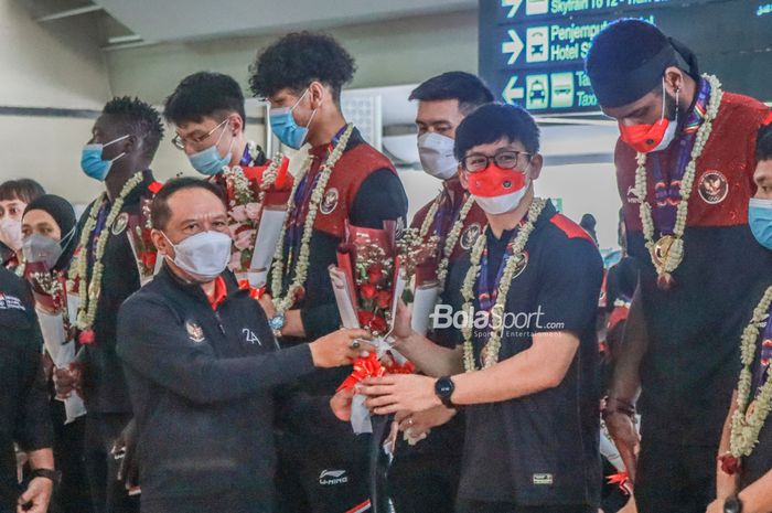 Menteri Pemuda dan Olahraga Republik Indonesia, Zainudin Amali (kanan), sedang memberikan bunga ke salah satu atlet basket bernama Abraham Damar di Terminal 3 Bandara Soekarno Hatta, Tangerang, Banten, 24 Mei 2022.