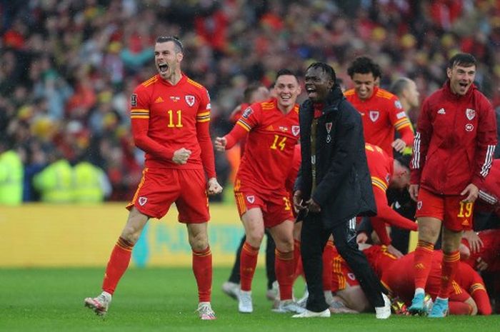 Gareth Bale (kiri) merayakan kelolosan timnas Wales ke Piala Dunia 2022 usai menekuk Ukraina di Cardiff City Stadium (5/6/2022).