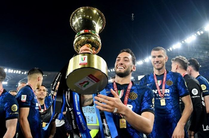 Hakan Calhanoglu berpose dengan trofi Coppa Italia milik Inter Milan usai menekuk Juventus di final (11/5/2022).