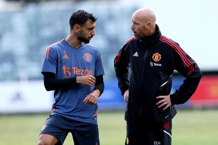 Pelatih Manchester United, Erik ten Hag, berbicara dengan Bruno Fernandes dalam sesi latihan pramusim di Perth (21/7/2022).