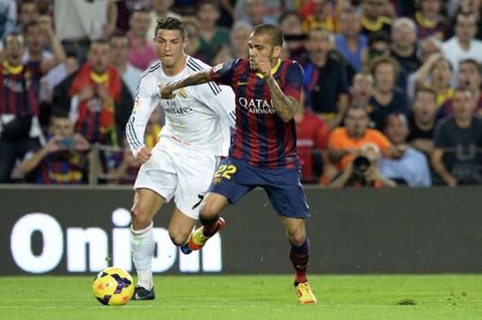 Dani Alves berduel dengan Cristiano Ronaldo dalam partai Barcelona vs Real Madrid di Camp Nou (26/10/2013).
