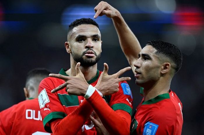 Morocco's forward #19 Youssef En-Nesyri (L) celebrates scoring  the opening goal with Morocco's defender #02 Achraf Hakimi during the Qatar 2022 World Cup quarter-final football match between Morocco and Portugal at the Al-Thumama Stadium in Doha on December 10, 2022. (Photo by PATRICIA DE MELO MORE