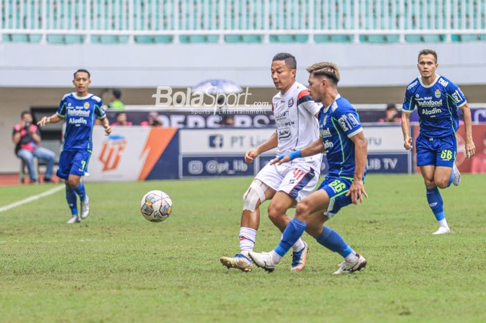 Pemain Arema FC, Dendi Santoso (kiri), sedang menguasai bola dan dibayangi bek asing Persib Bandung bernama Daisuke Sato (kanan) dalam laga pekan ke-26 Liga 1 2022 di Stadion Pakansari, Bogor, Jawa Barat, Kamis (23/2/2023).