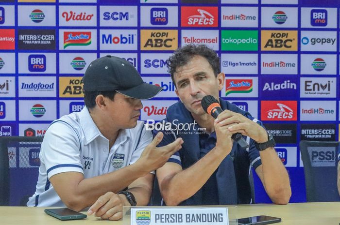 Pelatih Persib Bandung, Luis Milla (kanan), sedang berkomunikasi dengan asistennya bernama Yaya Sunarya (kiri) dalam sesi jumpa pers setelah laga pekan ke-29 Liga 1 2022 di Stadion Pakansari, Bogor, Jawa Barat, Rabu (8/3/2023).