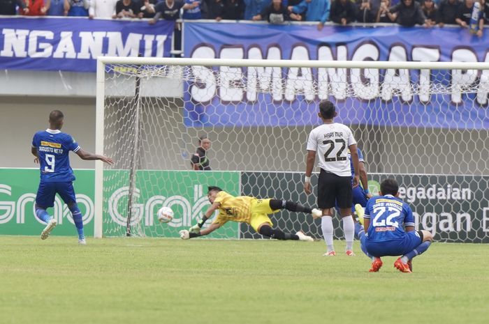Kiper Malut United FC, Aldhila Ray Redondo, menggagalkan penalti pemain PSIM, Augusto Neto, dalam laga Liga 2 di Stadion Mandala Krida, Yogyakarta, Sabtu (25/11/2023). 