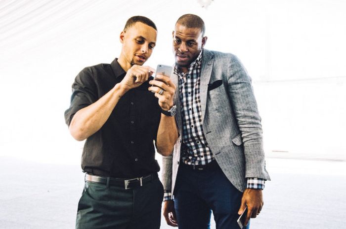 Stephen Curry (kiri) dan Andre Iguodala (kanan) sedang melihat instagram dari telepon genggam Curry.