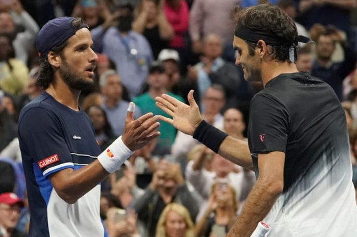 Petenis Spanyol, Feliciano Lopez (kiri), menyalami Roger Federer (Swiss) setelah melakoni laga pada turnamen AS Terbuka 2017 di USTA Billie Jean King National Tennis Center, New York, 2 September 2017. Lopez kalah dari Federer.