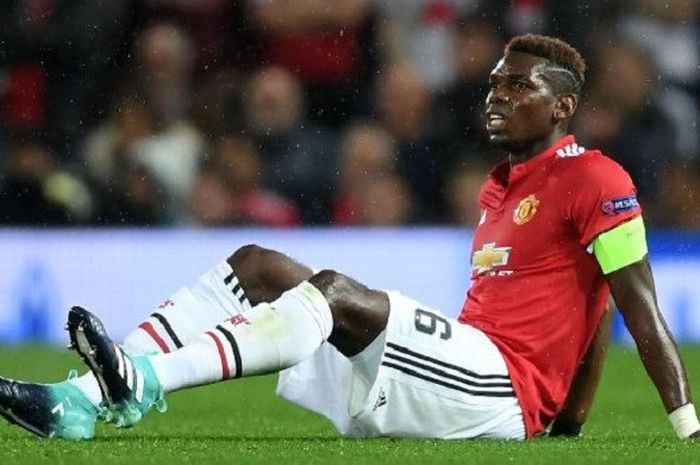 Gelandang andalan Manchester United, Paul Pogba terduduk di atas lapangan pertandingan karena cedera yang ia dapat saat melawan Basel, Rabu (13/9/2017).