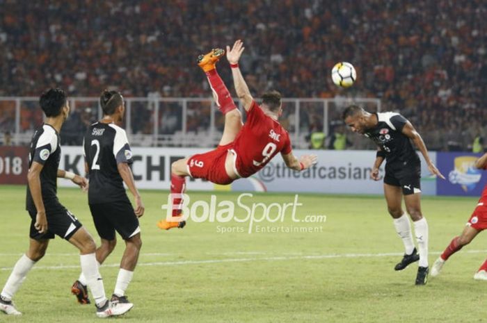Striker Persija, Marko Simic, melakukan tendangan akrobatik pada laga Piala AFC 2018 kontra Home United di Stadion Utama GBK, Selasa (15/5/2018).
