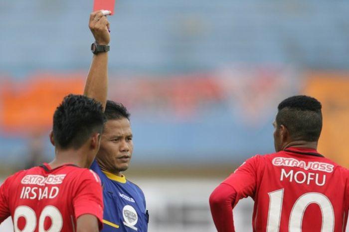 Wasit Iwan Sukoco memberikan kartu merah kepada pemain Semen Padang, Vendry Mofu (kanan), pada menit ke-32 pertandingan babak delapan besar Piala Jenderal Sudirman di Stadion Manahan Solo, Selasa (15/12/2015). Meski bermain dengan 10 pemain sejak menit ke-32, Semen Padang menang 2-1 atas Mitra Kukar.