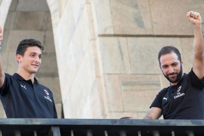 Dua pemain baru AC Milan, Gonzalo Higuain (kanan) dan Mattia Caldara, menyapa fans saat diperkenalkan di balkon Piazza Duomo, Milan, 3 Agustus 2018.