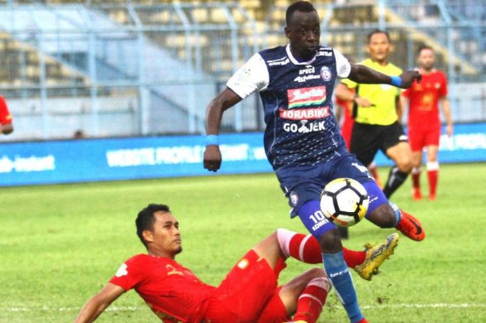 Gelandang Arema FC, Konate Makan melewati hadangan bek Barito Putera, Dandi Maulana A dalam lanjutan