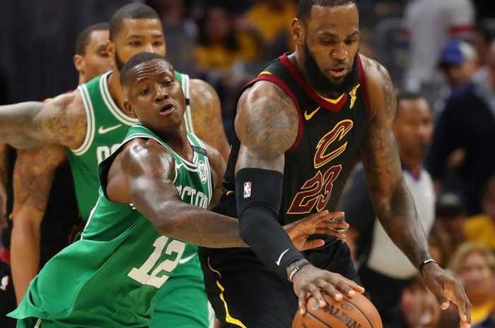 Pebasket megabintang Cleveland Cavaliers, LeBron James, mendribel bola seraya mendapat pengawalan ketat dari pemain Boston Celtics, Terry Rozier, pada laga gim ketiga seri final Wilayah Timur yang berlangsung di Quicken Loans Arena, Cleveland, Ohio, Amerika Serikat, Sabtu (19/5/2018).