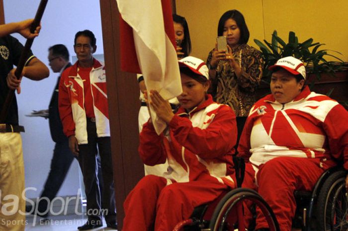 Atlet angkat berat paralimpik, Ni Nengah Widiasih, sedang mencium bendera Merah Putih saat pelepasan kontingen Indonesia ke ASEAN Paragames 2017.