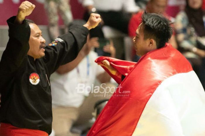 Pesilat Indonesia, Komang Harik Adi Putra, memenangi medali emas melawan Jamari Maj (Malaysia) untuk kelas tarung 65-70kg.