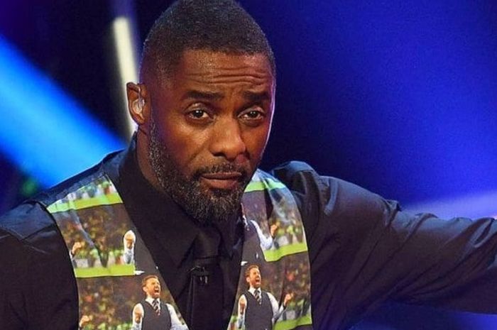 Idris Elba memakai rompi dengan motif wajah Gareth Southgate