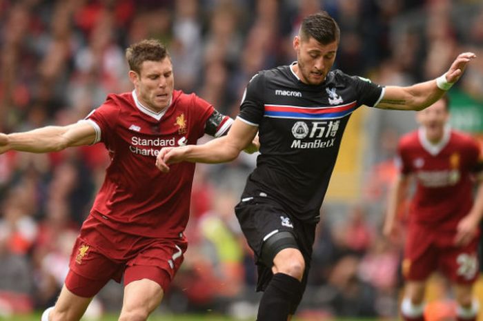 Pemain Liverpool, James Milner, berebut bola dengan pemain Crystal Palace dalam laga di Anfiel pada Sabtu (19/8/2017)