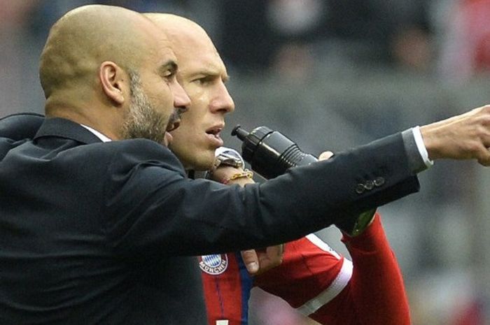 Winger Belanda, Arjen Robben (kanan), mendapat arahan dari Pep Guardiola saat melatih Bayern Muenchen di tahun 2014.