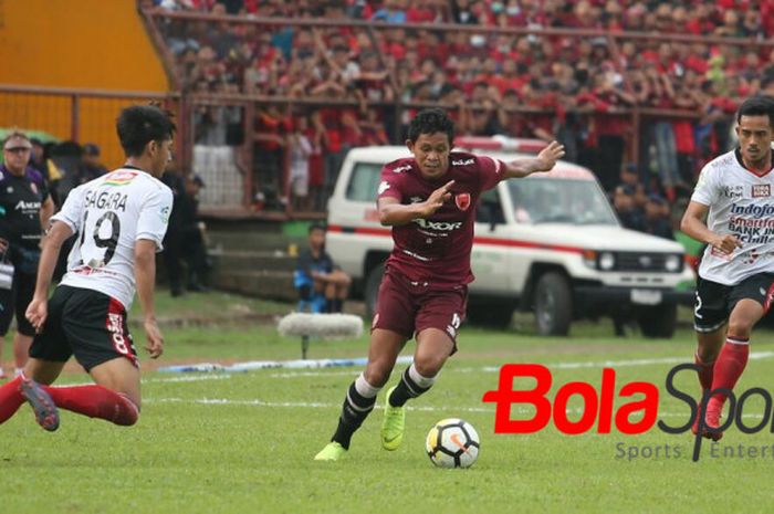  Gelandang PSM Makassar, Rizky Ahmad Pellu di antara dua pemain Bali United, Hanis Sagara Putra (kir