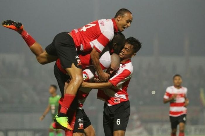 Tiga pemain Madura United: Peter Odemwingie (atas), Greg Nwokolo (dua dari atas), dan Andik Rendika Rama (kanan) mengerubuti gelandang Dane Milovanovic setelah sang pemain mencetak gol keempat timnya ke gawang PS TNI pada laga pekan ketujuh Liga 1 musim 2017 di Stadion Gelora Bangkalan, Jumat (19/5/2017) malam. 