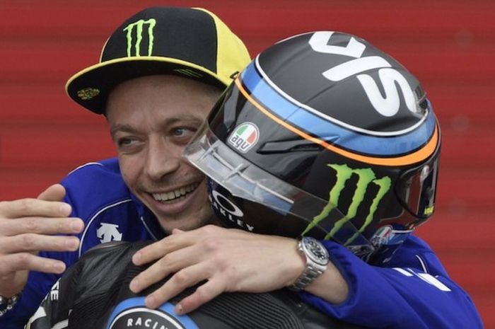 Pebalap Movistar Yamaha MotoGP asal Italia, Valentino Rossi, memberikan selamat kepada pebalap Moto3 dari Sky Racing Team VR46, Andrea Migno (Italia), yang finis di urutan kelima pada balapan GP Argentina di Autodromo Termas de Rio Hondo, Minggu (9/4/2017).