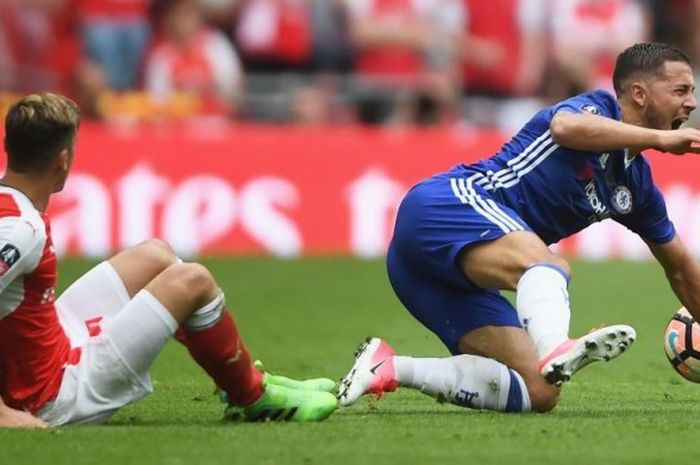 Penyerang Chelsea, Eden Hazard, meringis kesakitan setelah mendapat tackle dari gelandang Arsenal, Mesut Oezil, pada laga final Piala FA di Stadion Wembley, London, Inggris, 27 Mei 2017.