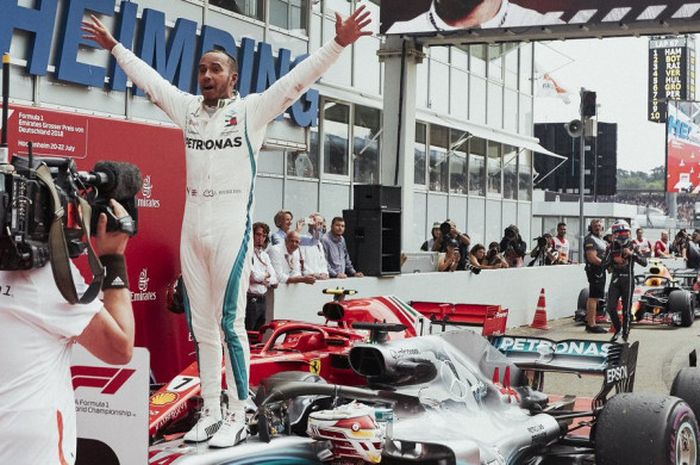 Pebalap Mercedes, Lewis Hamilton, merayakan kemenangannya pada balapan GP Jerman di Sirkuit Hockenheim, Minggu (22/7/2018).