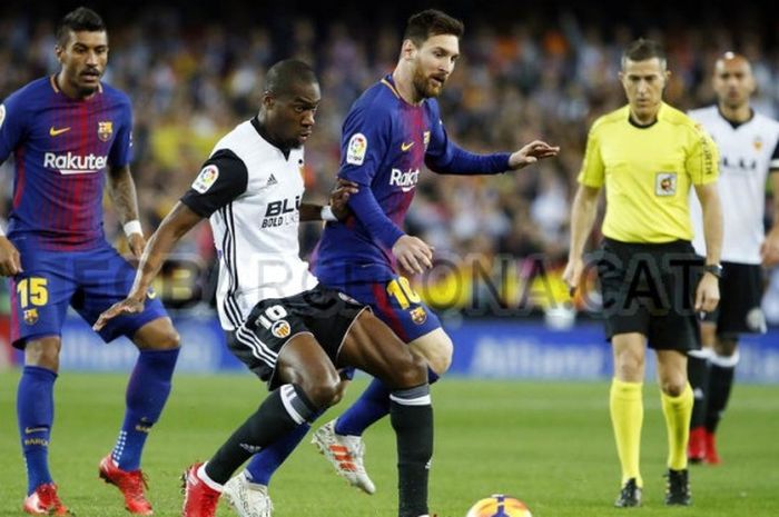 Penyerang Barcelona Lionel Messi (tiga dari kiri) sedang menggiring bola dan dikawal oleh gelandang Valencia Geoffrey Kondogbia dalam laga pekan 13 Liga Spanyol pada Senin (27/11/2017) di Stadion Mestalla, Valencia.