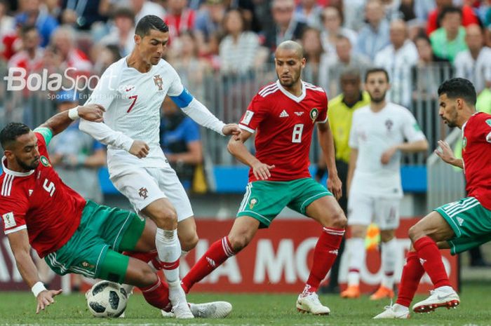 Kapten Portugal, Cristiano Ronaldo, dihadang para pemain Maroko pada laga Grup B Piala Dunia 2018 di Stadion Luzhniki, Moskow, Rabu (20/6/2018).