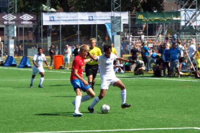 Pemain tim LKG-SKG Indonesia, Rafli Rafa Zahid, menekan pertahanan Kinna IF pada laga perdelapan final Piala Gothia 2018, Jumat (20/072018) di Lapangan Heden, Gothenburg, Swedia. Pada laga itu, tim LKG-SKF menang dengan skor 2-1.