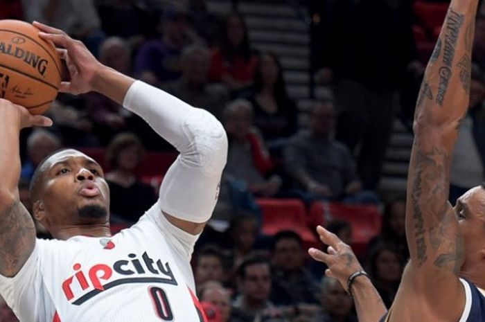 Pebasket Portland Trail Blazers, Damian Lillard (jersey putih, #0), bersiap melepas tembakan melewati penjagaan pemain Utah Jazz, George Hill, pada laga musim reguler NBA 2016-2017 yang digelar di Moda Center, Portland, Oregon, Amerika Serikat, Selasa (25/10/2016). Blazers menang 113-104.