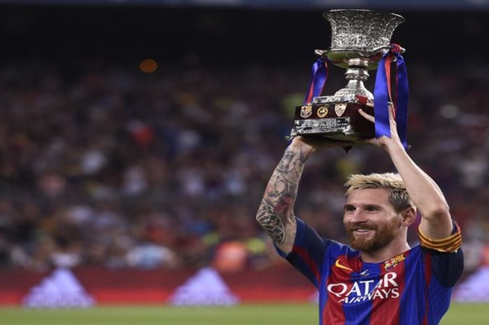  Lionel Messi mengangkat trofi Piala Super Spanyol sebagai kapten tim FC Barcelona setelah menundukkan Sevilla FC di Camp Nou, Rabu (17/8/2016) 