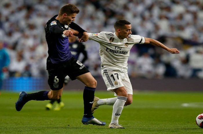 Penyerang sayap Real Madrid, Lucas Vazquez, berduel dengan pemain Leganes, Gerard Gumbau, dalam laga leg pertama Copa del Rey di Stadion Santiago Bernabeu, Rabu (9/1/2019).