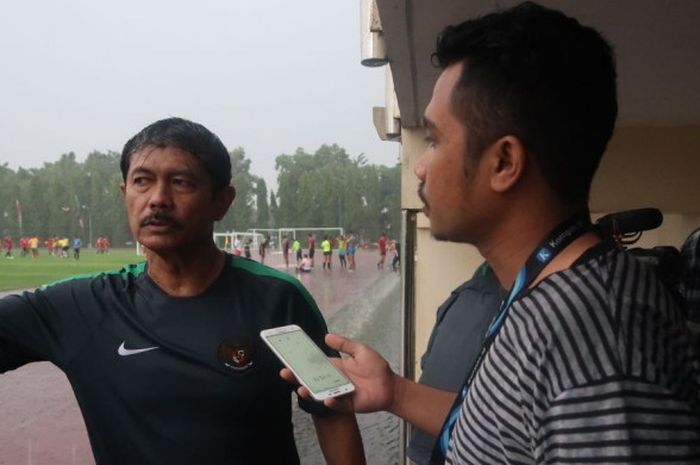Pelatih Timnas U-19, Indra Sjafri diwawancarai BolaSport.com usai memimpin TC Hari Keenam di Universitas Negeri Yogyakarta, Jumat (25/5/2018) dengan guyuran hujan deras.