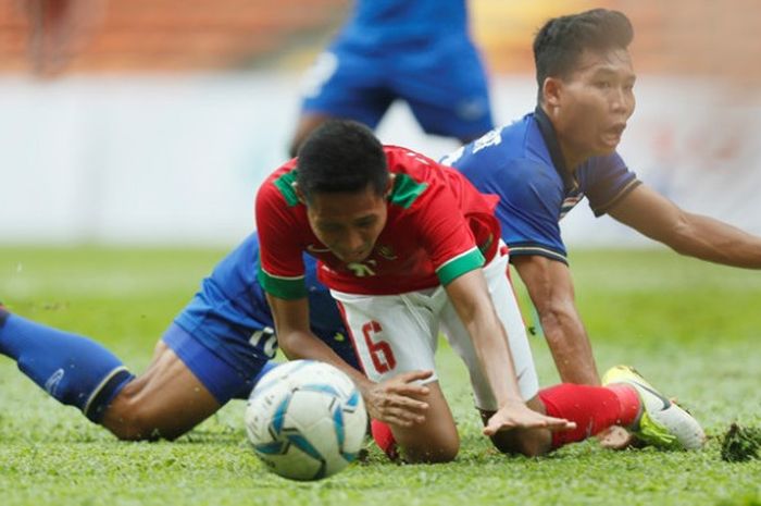 Gelandang timnas U-22 Indonesia, Evan Dimas terjatuh setelah dilanggar pemain timnas U-22 Thailand pada laga perdana kedua tim pada Grup B SEA Games 2017 di Stadion Shah Alam, Selangor, 15 Agustus 2017. 