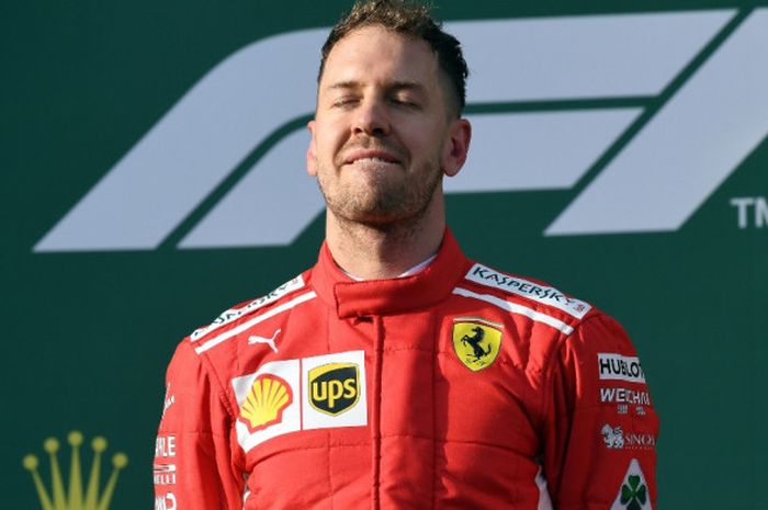 Pebalap Ferrari, Sebastian Vettel, memenjamkan mata untuk menikmati momen kemenangannya pada GP Australia yang menjadi seri pembuka Formula 1 (F1) 2018. Vettel tampil sebagai kampiun pada balapan di Melbourne, Minggu (25/3/2018).