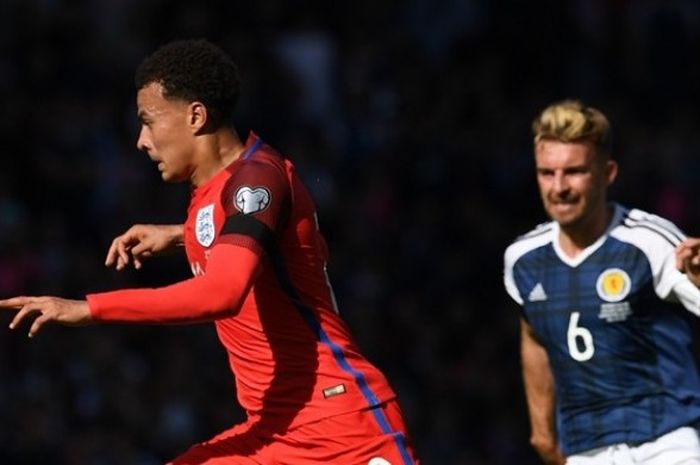  Gelandang timnas Inggris, Dele Alli (kiri), coba mengelabui pemain Skotlandia pada partai Kualifikasi Piala Dunia zona Eropa Grup F di Hampden Park, Sabtu (10/6/2017). 